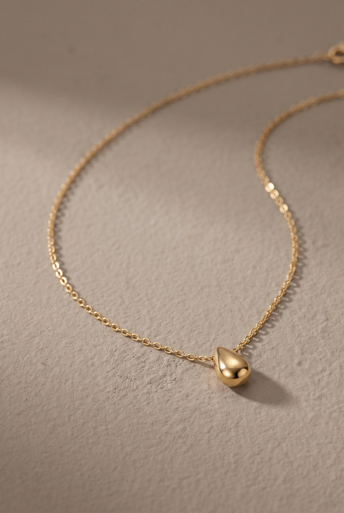 DropIQ gold teardrop pendant necklace on a fine cable chain